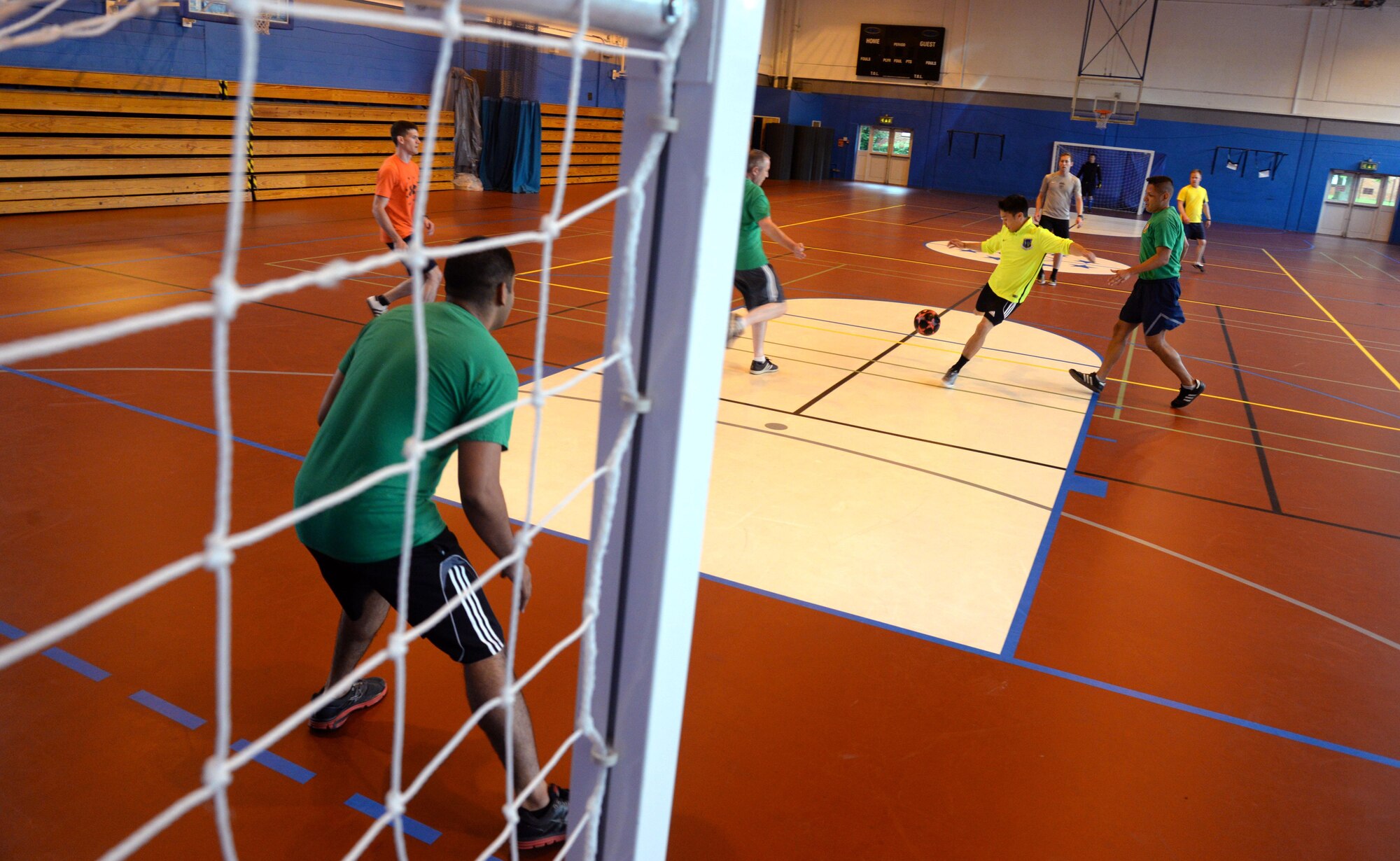 U.S. Air Force Airmen assigned to the 100th Security Forces Squadron and 100th Force Support Squadron compete at indoor soccer during a Marauder Melee event June 16, 2016, on RAF Mildenhall, England. The event was designed to foster morale and friendly competition through sports, games and a concert for Airmen and their families. (U.S. Air Force photo by Staff Sgt. Kate Thornton/Released)