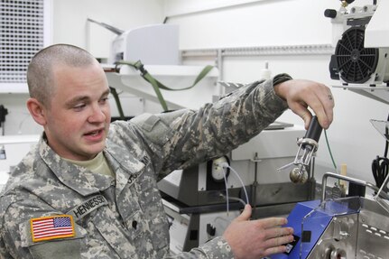 U.S. Army Reserve Spc. Matthew Hennessey, a native of Orwell, Ohio, and petroleum laboratory specialist assigned to the 475th Quartermaster Group, based out of Farrell, Pa., observes the remains of a fuel sample after the contamination test ran through the Distillation Apparatus at Fort A.P. Hill, Va. This is all part of the 2016 Quartermaster Liquid Logistics Exercise, which consists of multiple units operating at various locations providing safe, responsive, on-time petroleum support to specified Army Reserve exercises and Department of Defense customers.  (U.S. Army photo by Spc. Jack Hillard, 372nd Mobile Public Affairs Detachment)