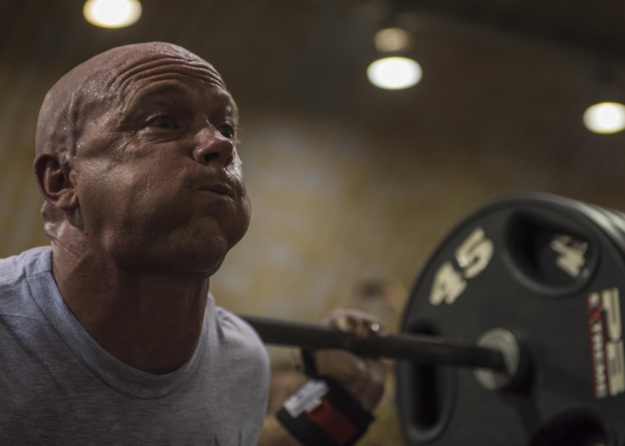 Capt. Benjamin Swope, 455th Expeditionary Security Forces Squadron, competes in the squat portion of Bagram’s Strongest Woman and Man competition, June 18, 2016, Bagram Airfield, Afghanistan. Swope was the overall winner in the squat, bench, and deadlift, men’s division. (U.S. Air Force photo by Senior Airman Justyn M. Freeman)
