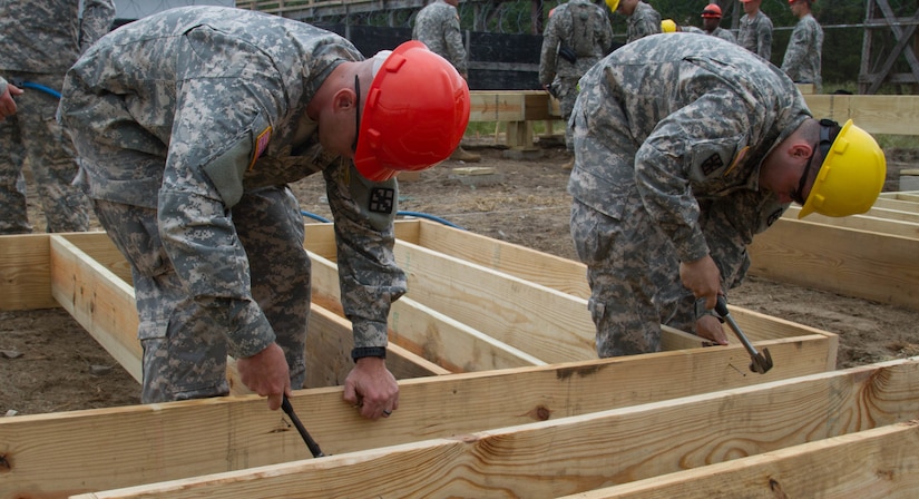 JOINT BASE MCGUIRE-DIX-LAKEHURST, N.J. - Soldiers of 412th Engineer Company, based in Scranton, Pa., hammer nails into a frame for a detainee complex during training exercise Castle Installation Related Construction 2016. (U.S. Army photo by Spc. Gary R. Yim, 372nd Mobile Public Affairs Detachment)