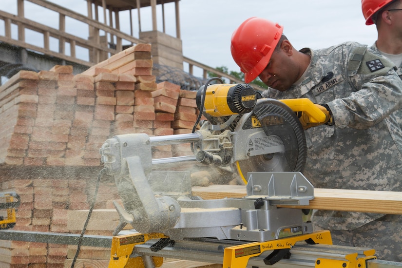 JOINT BASE MCGUIRE-DIX-LAKEHURST, N.J. - Pittston, Pa. native Sgt. Kieran Carrington of 412th Engineer Company, based in Scranton, Pa., cuts wood for a frame for a detainee complex during training exercise Castle Installation Related Construction 2016. (U.S. Army photo by Spc. Gary R. Yim, 372nd Mobile Public Affairs Detachment)
