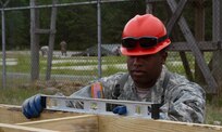 JOINT BASE MCGUIRE-DIX-LAKEHURST, N.J. - Tobyhanna, Pa. native Spc. Kenneth Jones of 412th Engineer Company, based in Scranton, Pa., checks that a frame for a detainee complex is level during training exercise Castle Installation Related Construction 2016. (U.S. Army photo by  Spc. Gary R. Yim, 372nd Mobile Public Affairs Detachment)