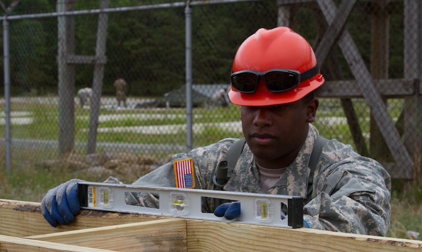 JOINT BASE MCGUIRE-DIX-LAKEHURST, N.J. - Tobyhanna, Pa. native Spc. Kenneth Jones of 412th Engineer Company, based in Scranton, Pa., checks that a frame for a detainee complex is level during training exercise Castle Installation Related Construction 2016. (U.S. Army photo by  Spc. Gary R. Yim, 372nd Mobile Public Affairs Detachment)