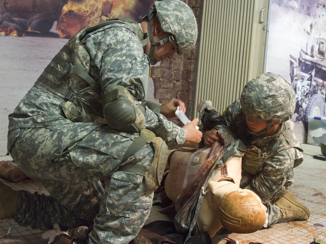 JOINT BASE MCGUIRE-DIX-LAKEHURST, N.J. - Pfc. Nicholas Przybocki, a combat engineer, right, rolls a mannequin over so Spc. Brody Evan Black, a carpenter masonry specialist, can treat the wound on its back during combat lifesaver training conducted at training exercise Castle Installation Related Construction 2016. Przybocki is with Headquarters Headquarters Company, 365th Engineer Battalion based in Schuylkill Haven, Pa., and Black is a member of the New Cumberland, Pa.-based 358th Engineer Company. Both are Army Reserve Soldiers (U.S. Army photo by Sgt. Anshu Pandeya, 372nd Mobile Public Affairs Detachment)