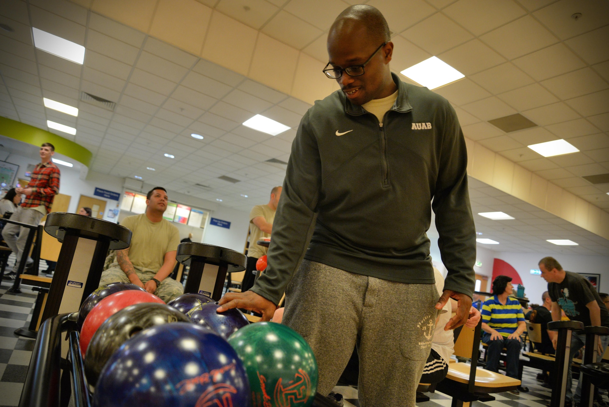 U.S. Air Force Tech. Sgt. Roshaun Williams, 488th Intelligence Squadron production controller, picks out a bowling ball during a bowling tournament as part of Marauder Melee June 16, 2016, on RAF Mildenhall, England. The Marauder Melee is an annual competition featuring several events which promote fitness, friendly competition and camaraderie among various units on base.  (U.S. Air Force photo by Senior Airman Christine Halan/Released)