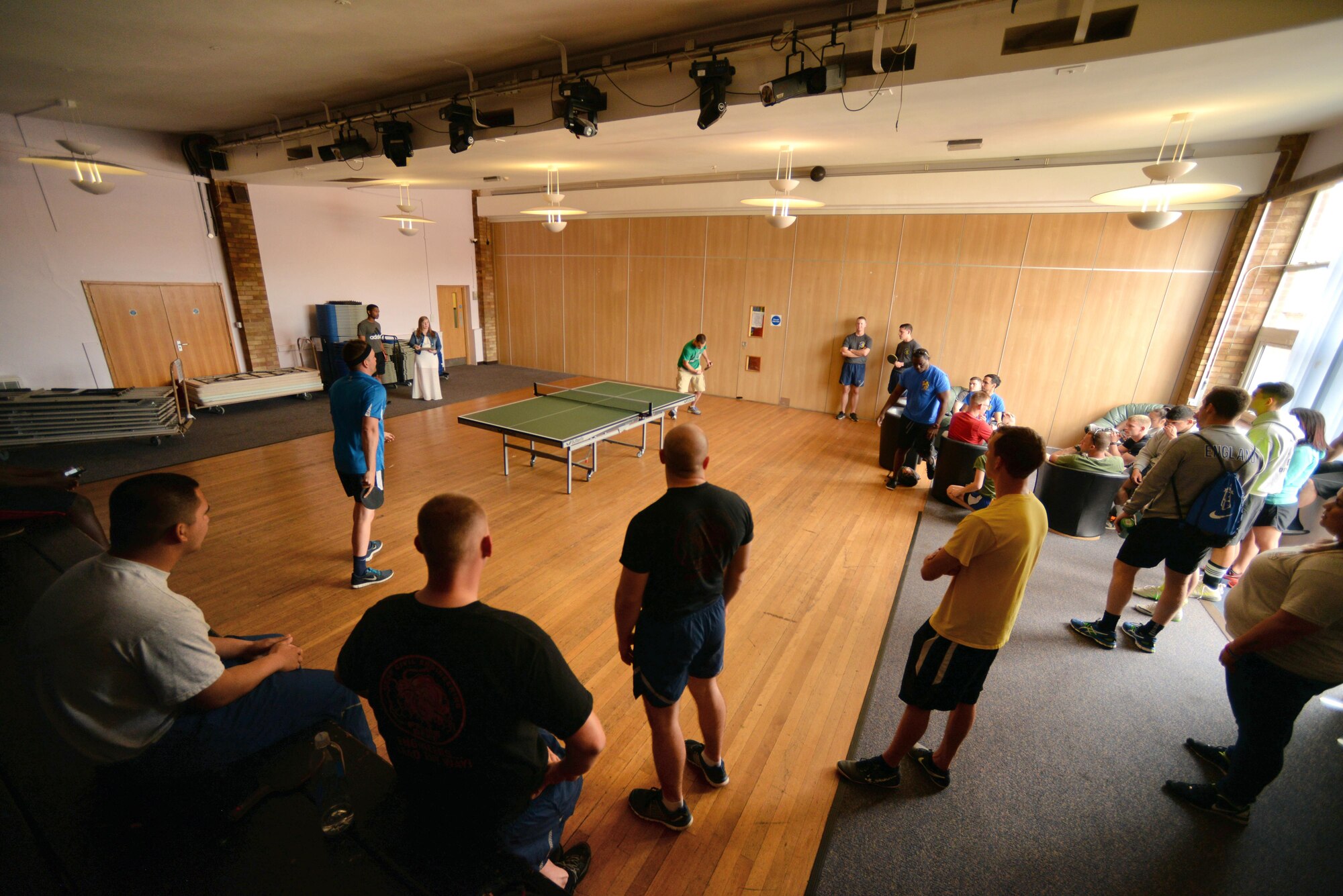 Team Mildenhall Airmen gather to watch and play a game of ping-pong for Marauder Melee June 20, 2016, at the Bob Hope Community Center on RAF Mildenhall, England. The Marauder Melee is an annual competition featuring several events which promote fitness, friendly competition and camaraderie among various units on base. (U.S. Air Force photo by Senior Airman Christine Halan/Released)