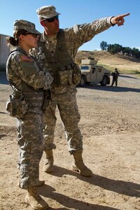 U.S. Army Reserve Sgt. David Tedrow, Observer Coach Trainer, 3rd Battalion, 381st Regiment, 91st Training Division, Grand Prairie, Texas, and 1st Lt. Lisa Stone, 3rd Battalion, 337th Regiment, 4th Calvary Division Training Support Battalion, Fort Knox, Ky., discuss trainees' performance during a response to a civil unrest training mission as part of Combat Support Training Exercise 91-16-02, Fort Hunter Liggett, Calif., June 14, 2016. As the largest U.S. Army Reserve training exercise, CSTX 91-16-02 provides Soldiers with unique opportunities to sharpen their technical and tactical skills in combat-like conditions. (U.S. Army photo by Spc. James Lefty Larimer, 367th Mobile Public Affairs Detachment)