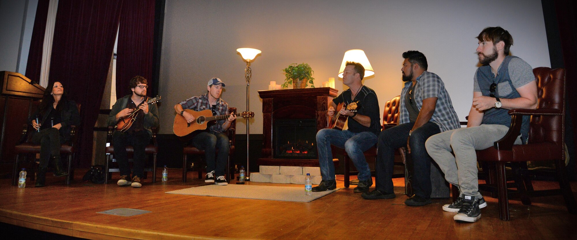 Lucas Hoge, third from right, country singer-songwriter and musician, covers a song June 15, 2016, at the base theater on RAF Mildenhall, England. Hoge and his band spoke with Team Mildenhall members about the power of music and how it has helped him and others stay resilient. (U.S. Air Force photo by Senior Airman Christine Halan/Released)