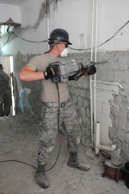 Airman 1st Class Joey Wurzelbacher, from the Kentucky Air National Guard’s 123rd Civil Engineer Squadron, removes old brick and tile from a kitchen wall of a school in Chisinau, Moldova, June 4, 2016. More than 35 Airmen from the unit renovated the institution, which is the only school in Moldova specifically for deaf and special-needs students. The humanitarian project was a partnership with the Office of Defense Cooperation and U.S. European Command, with funds being provided by the National Guard Bureau. (U.S. Air National Guard photo/Tech. Sgt. Vicky Spesard)
