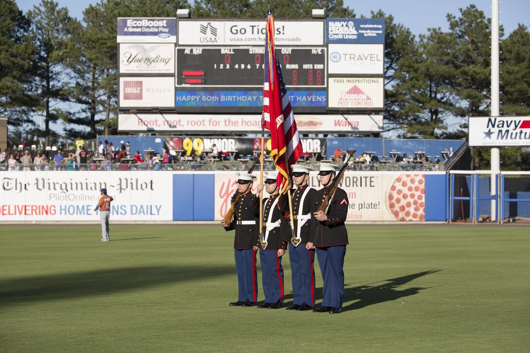 NORFOLK, Va. - Marines with U.S. Marine Corps Forces Command serve as the color guard during the Norfolk Tides' Marine Night, June 18. Marine Night was held in honor of the brave men and woman who have served, are currently serving in the Marine Corps and those who paid the ultimate sacrifice. (U.S. Marine Corps photo by Cpl. Logan Snyder)