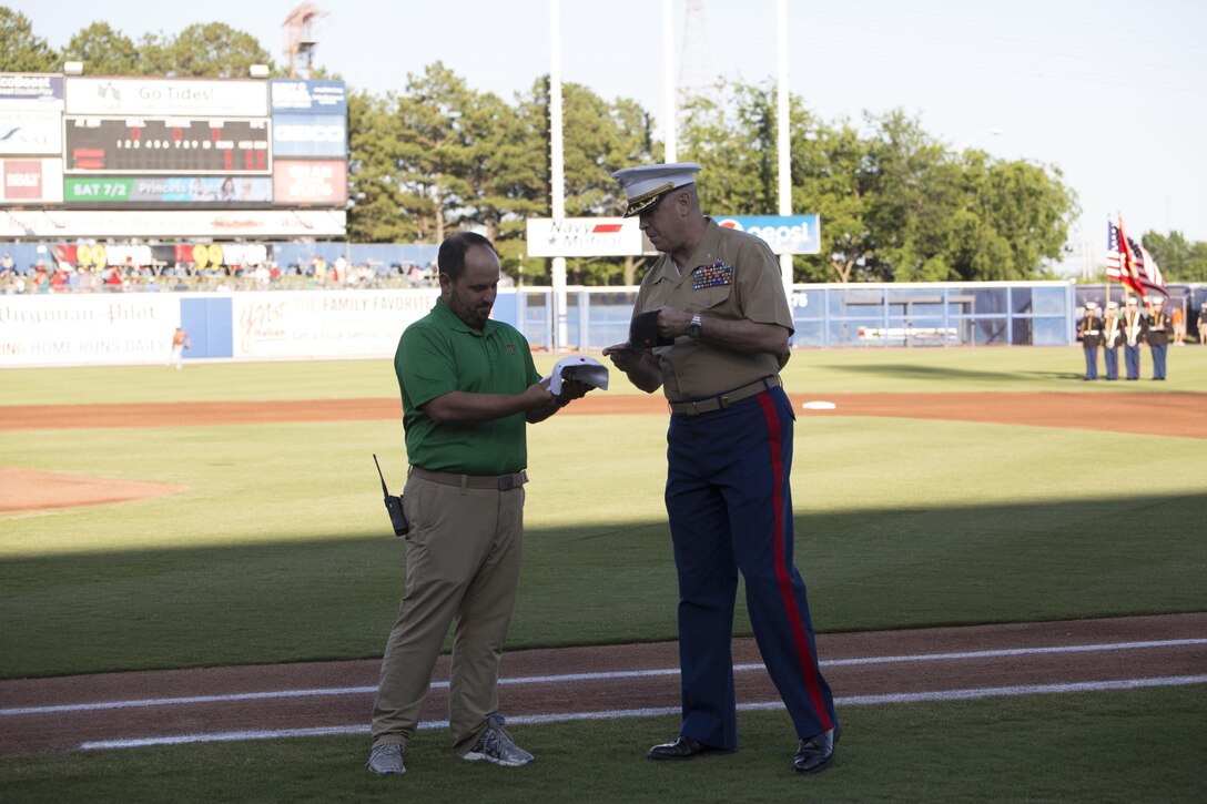 NORFOLK, Va. – Colonel Russell Smith, U.S. Marine Corps Forces Command chief of staff, exchange hats with the Norfolk Tides’ General Manager Joe Gregory on Marine Night, June 18. Col. Smith is a Rochester, N.H. native. Marine Night was held in honor of the brave men and women who have served, are currently serving in the Marine Corps and those who paid the ultimate sacrifice.  (U.S. Marine Corps photo by Cpl. Logan Snyder)