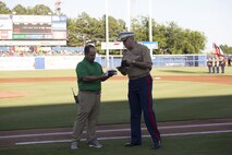 NORFOLK, Va. – Colonel Russell Smith, U.S. Marine Corps Forces Command chief of staff, exchange hats with the Norfolk Tides’ General Manager Joe Gregory on Marine Night, June 18. Col. Smith is a Rochester, N.H. native. Marine Night was held in honor of the brave men and women who have served, are currently serving in the Marine Corps and those who paid the ultimate sacrifice.  (U.S. Marine Corps photo by Cpl. Logan Snyder)