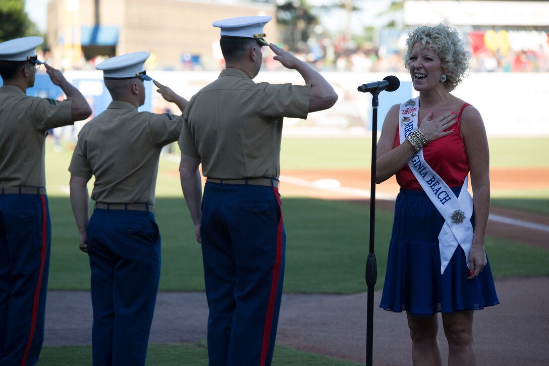 NORFOLK, Va. – Tiffany Jewell Borshein, Mrs. Virginia Beach, sings the national anthem during the Norfolk Tides’ Marine Night, June 18. Marine Night was held in honor of the brave men and women who have served, are currently serving in the Marine Corps and those who paid the ultimate sacrifice.  (U.S. Marine Corps photo by Cpl. Logan Snyder)
