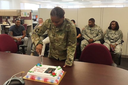 Maj. Erna Faber, Chief of Operations and Plans, 85th Support Command, cuts into her cake on June 10, 2016, celebrating her 30 year anniversary as a member of the United States Army. 
(Photo by Sgt. 1st Class Anthony Taylor)