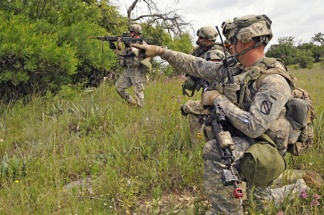 Army Staff Sgt. Matthew Daigre, foreground, points out possible opposing force vehicles during a live-fire training exercise at Fort Hood, Texas, June 12, 2016. Daigre is assigned to the Mississippi Army National Guard’s Company B, 1st Battalion, 155th Infantry Regiment. Mississippi Army National Guard photo by Staff Sgt. Shane Hamann