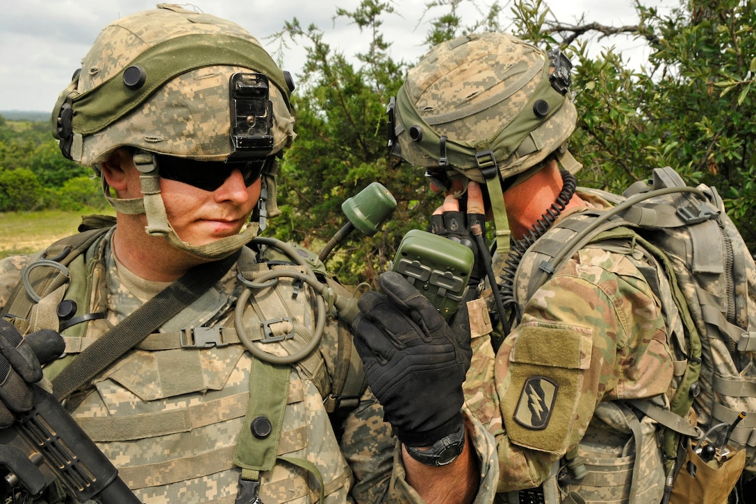 Army Spc. Chris Carlisle, left, and Sgt. Sheldon Roberson report an opposing force position during a live-fire training exercise at Fort Hood, Texas, June 12, 2016. Carlisle and Roberson are assigned to the Mississippi Army National Guard’s Company B, 1st Battalion, 155th Infantry Regiment. Mississippi Army National Guard photo by Staff Sgt. Shane Hamann