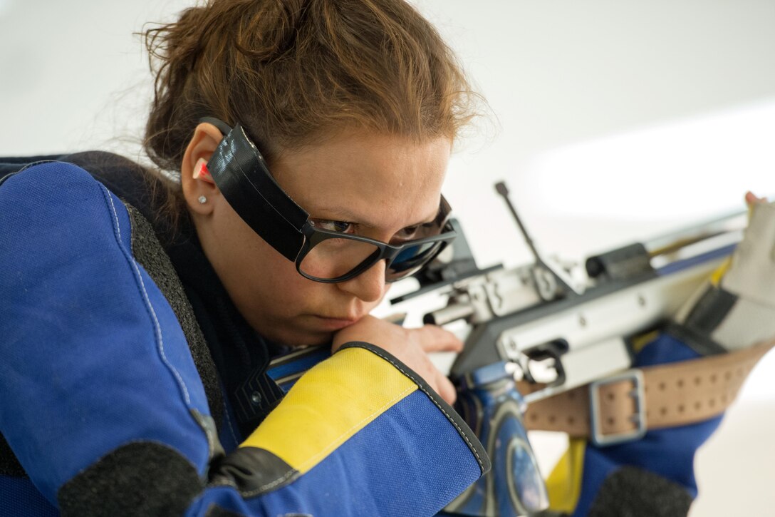 Navy Chief Petty Officer Maria Torres listens for her score during an air rifle competition at the 2016 Department of Defense Warrior Games at the U.S. Military Academy in West Point, N.Y., June 19, 2016. DoD photo by EJ Hersom