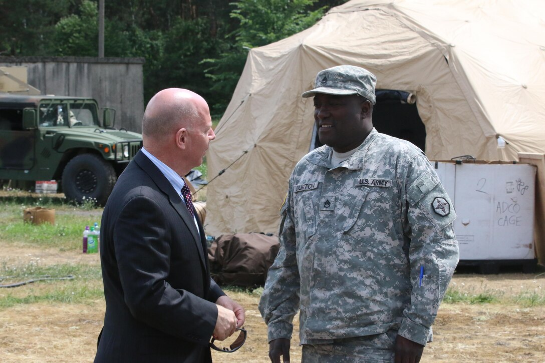 Mr. James Balocki, Chief Executive Officer U.S. Army Reserve, discusses sustainment operations with U.S. Army Reserve Staff Sgt. Donald Burton, an information technology specialist with the 364th Expeditionary Sustainment Command, Marysville, Washington, during a visit to a training site outside of Warsaw, Poland June 14, during Anakonda 16. Anakonda 16 is a Polish-led national event that seeks to train, exercise and integrate Polish national command and force structures into an Allied, joint, multinational environment. Exercises like Anakonda 16 help Army Reserve sustainment Soldiers understand how to quickly and efficiently move personnel and equipment in order to improve response time. (Photo by Capt. A. Sean Taylor, 649th RSG)