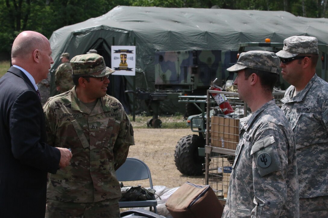 Mr. James Balocki, Chief Executive Officer U.S. Army Reserve, discusses sustainment operations with U.S. Army Reserve Soldiers attached to the 364th Expeditionary Sustainment Command, Marysville, Washington, during a visit to a training site outside of Warsaw, Poland June 14, during Anakonda 16. Anakonda 16 is a Polish-led national event that seeks to train, exercise and integrate Polish national command and force structures into an Allied, joint, multinational environment. Exercises like Anakonda 16 help Army Reserve sustainment Soldiers understand how to quickly and efficiently move personnel and equipment in order to improve response time. (Photo by Capt. A. Sean Taylor, 649th RSG)