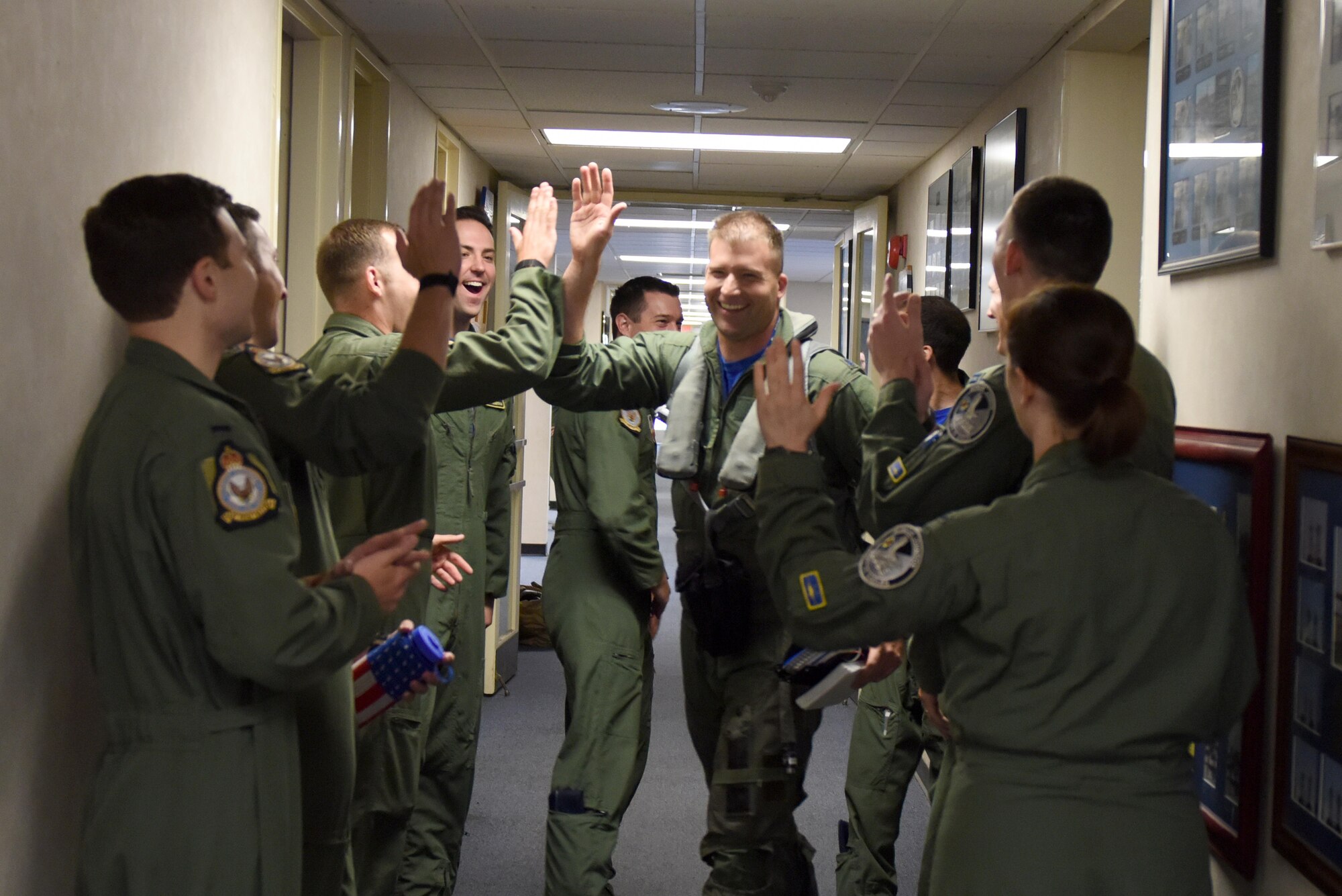 Lt. Col. Eric Schmidt, 334th Fighter Squadron director of operations, is greeted by members of the 334th FS prior to his final F-15E Strike Eagle flight June 17, 2016, at Seymour Johnson Air Force Base, North Carolina. Schmidt will depart Seymour Johnson AFB to become a T-38 Talon instructor pilot at Vance AFB, Oklahoma. (U.S. Air Force photo/Tech. Sgt. Chuck Broadway)