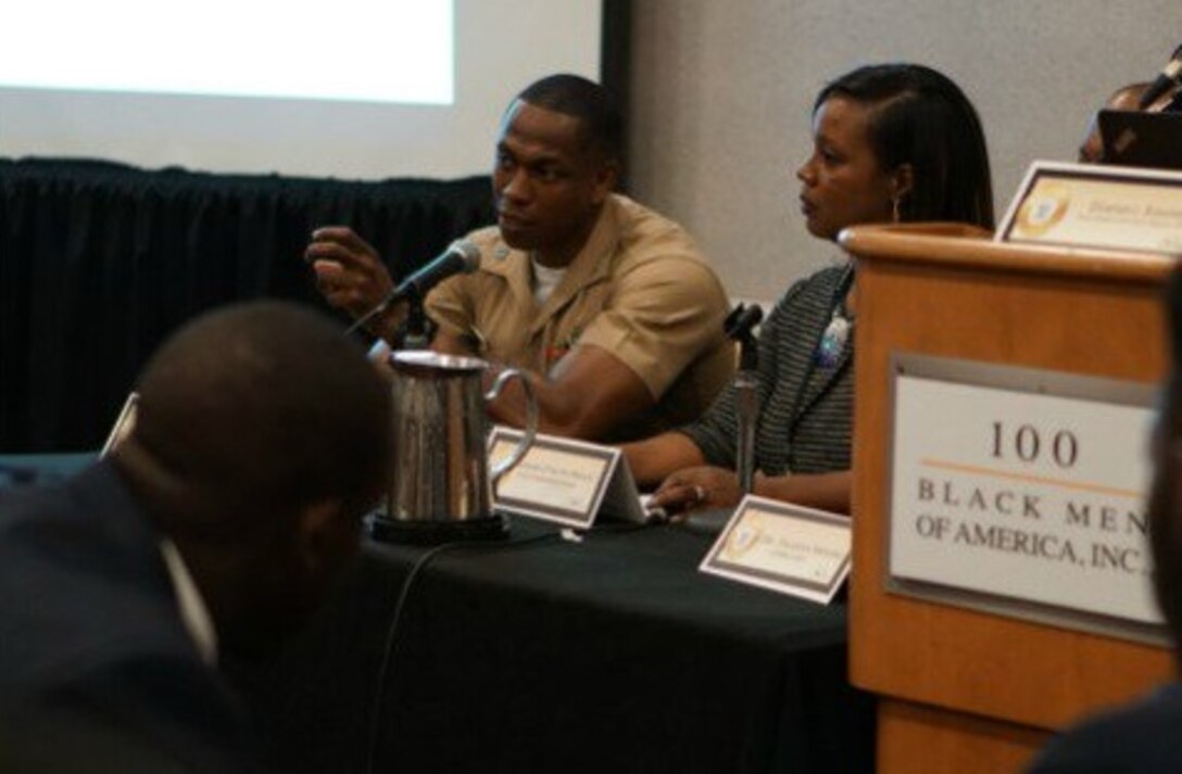 A Marine speaks about the values of leadership and discipline with attendees of the 100 Black Men of America, Inc. Conference in Atlanta, Ga., June 17. The non-profit organization provides mentors to underserved youth around the globe. Attending the event provides the Marine Corps with an opportunity to build relationships with influential community leaders who become brand ambassadors for the Corps. 