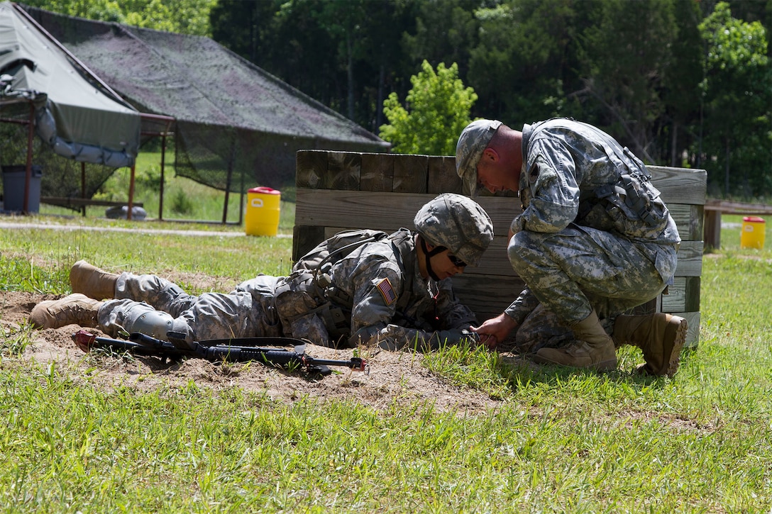 A Cadet Initial Entry Training candidate recieves instruction on the grenade range from Army Reserve Staff Sgt. Justin Callahan, an observer/trainer mentor attached to Task Force Wolf, during Cadet Summer Training Event, Ft. Knox, Ky., June 15.  (U.S. Army Reserve photo by SGT Karen Sampson/ Released)