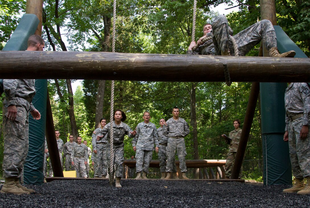 Army Reserve instructors attached to Task Force Wolf from Alpha Company, 2nd and 399th Training Battalion (ROTC) watch cadets attempt the swing, stop and jump obstacle on the confidence course during Cadet Summer Training event, Ft. Knox, Ky., July 19.  (U.S. Army Reserve photo by SGT Karen Sampson/ Released)