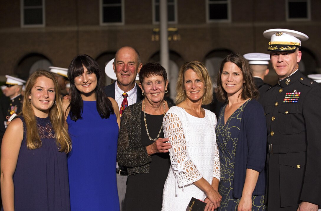 Senior Aide-de-Camp to the Commandant of the Marine Corps Lt. Col. Andrew Priddy (far right) and his guests (from left): Ms. Jensen Meyer, Ms. Lauren Meyer, Dr. Bill Murphy, Mrs. Linda Murphy, Mrs. Kelyn Meyer, and Mrs. Kirsten Priddy attend an Evening Parade at Marine Barracks, Washington, D.C., (“8th & I”), June 3, 2016. 