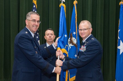 General John Hyten, Commander, Air Force Space Command, transfers the 24th Air Force Guidon to Maj. Gen. Christopher Weggeman, Commander, 24th Air Force during the change of command ceremony 17 June (US Photo by Johnny Saldivar). 