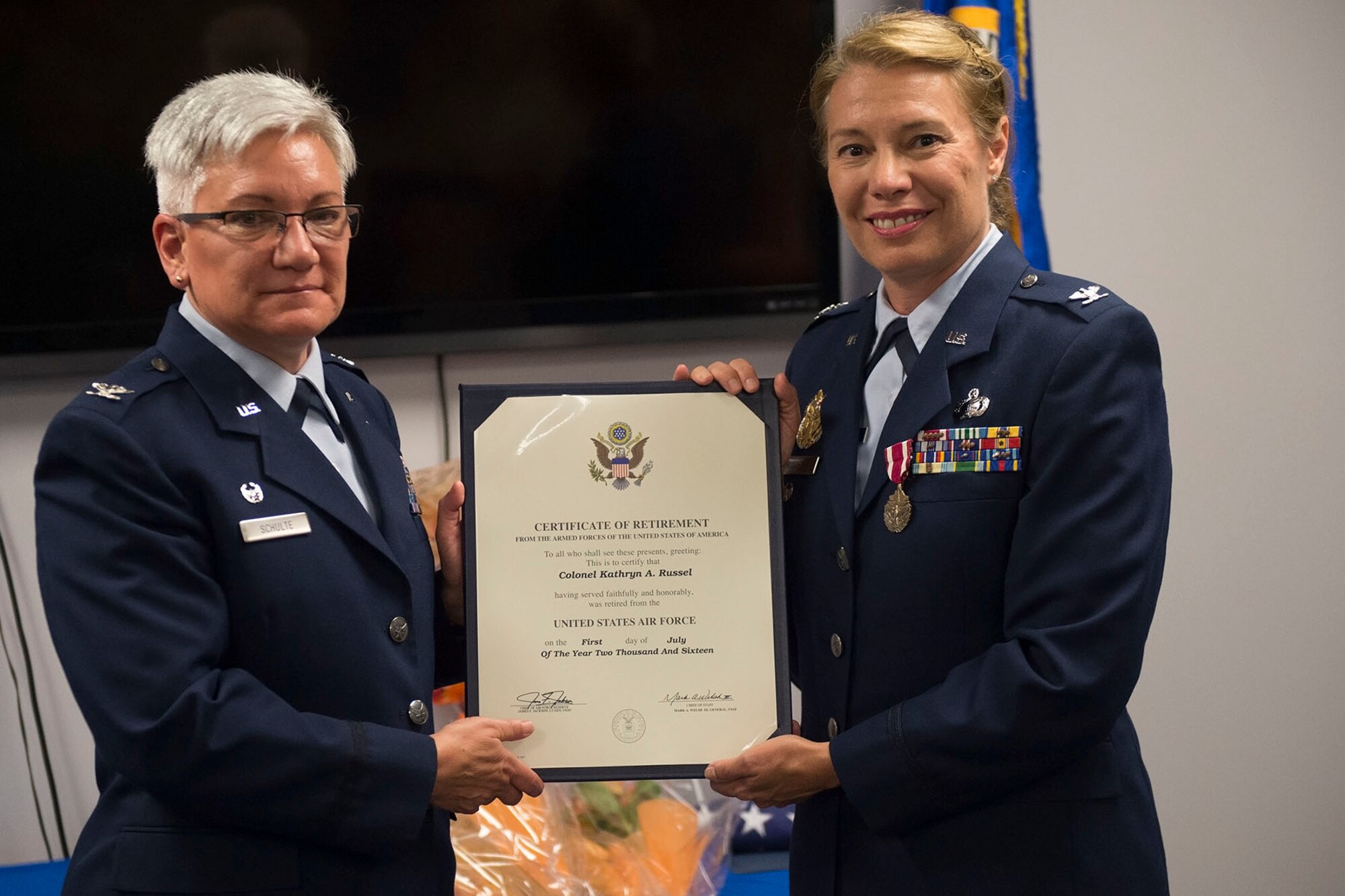 Col. Ann Schulte, 434th Maintenance Group commander, presents Col. Kathryn Russel, 434th Air Refueling Wing inspector general, with her certificate of retirement at Grissom Air Reserve base, Ind., June 5th, 2016. Russel retired after 28 years of service. (U.S. Air Force photo/Staff Sgt. Jami K. Lancette)