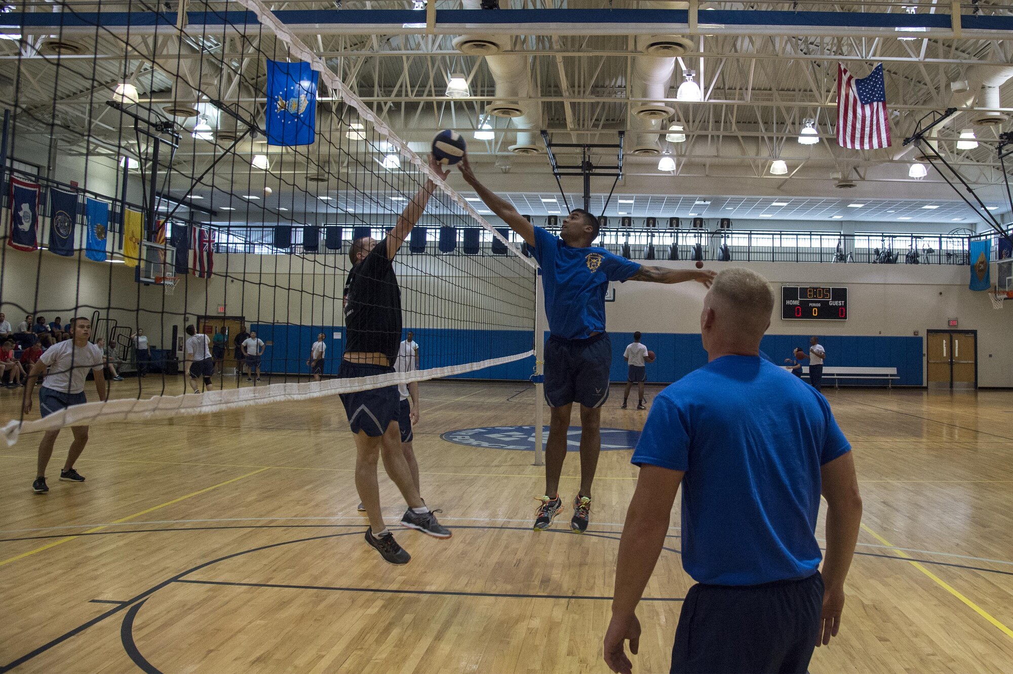 U.S. Air Force Airmen from the 23d Mission Support Group rally during a six-on-six volleyball tournament as part of Sports Day, June 17, 2016, at Moody Air Force Base, Ga. During this game, the 23d Logistics Readiness Squadron, right, took on the 23d Communications Squadron. (U.S. Air Force photo by Airman 1st Class Janiqua P. Robinson/Released)