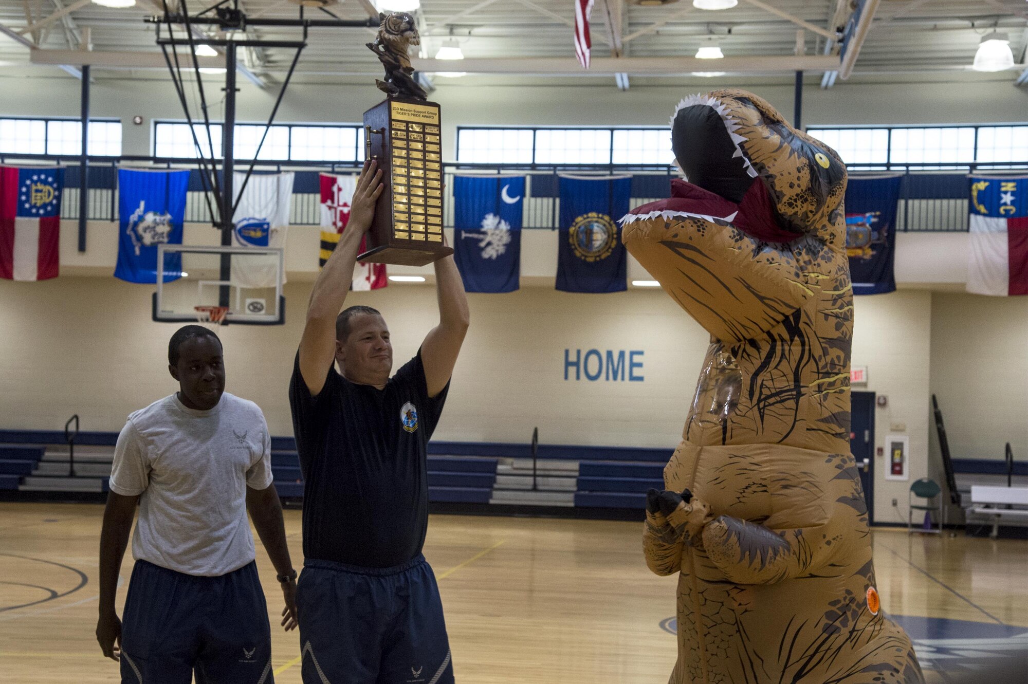 U.S. Air Force Airmen from the 23d Communications Squadron accept the trophy during Sports Day, June 17, 2016, at Moody Air Force Base, Ga. Each event was worth points and the winner was determined by the overall amount each squadron earned throughout the day. (U.S. Air Force photo by Airman 1st Class Janiqua P. Robinson/Released)