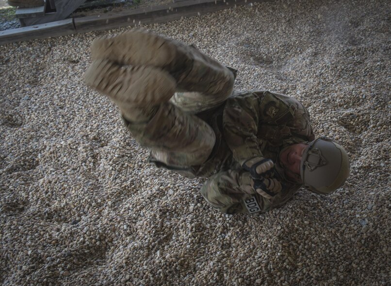 U.S. Air Force Col. Michael Ross, 820th Base Defense Group commander, rolls while practicing his landing technique onto a gravel pit, June 16, 2016 at Moody Air Force Base, Ga. Ross performed his final jump as the 820th BDG commander on June 17, 2016 over the Lee Fulp drop zone. (U.S. Air Force photo by Tech. Sgt. Zachary Wolf/Released)