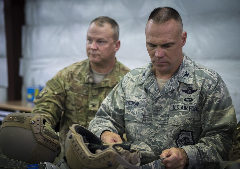 U.S. Air Force Col. Eric Trychon, right, 93d Air Ground Operations Wing vice commander, and Col. Michael Ross, 820th Base Defense Group commander, check their jump gear, June 16, 2016 at Moody Air Force Base, Ga. Each jumper checks their gear to ensure everything is rigged correctly and nothing is missing. (U.S. Air Force photo by Tech. Sgt. Zachary Wolf/Released)