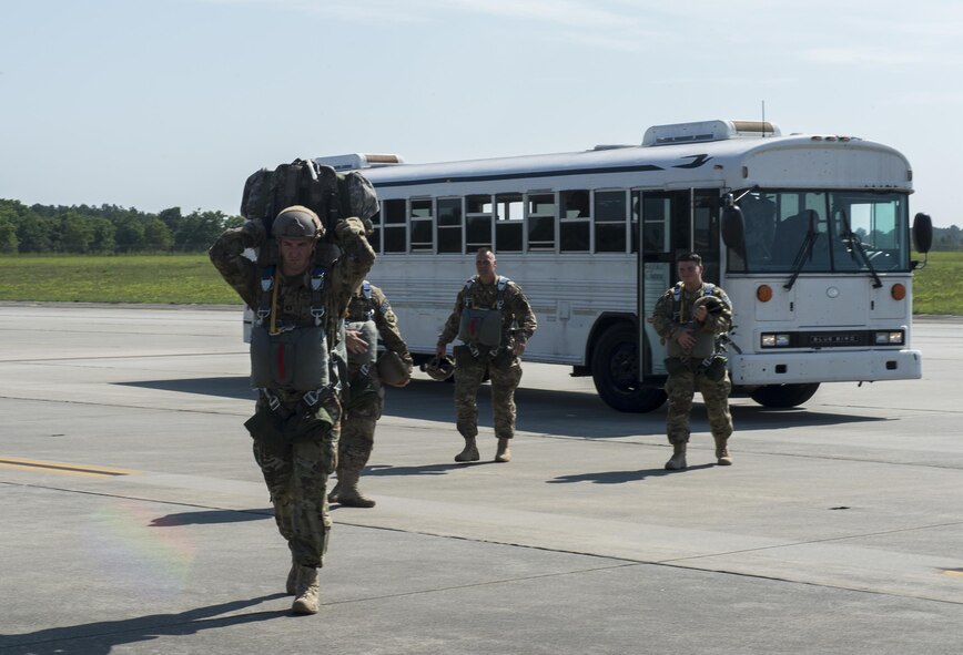 U.S. Air Force Airmen from the 93d Air Ground Operations Wing depart a bus to load onto an HC-130J Combat King II, June 17, 2016 at Moody Air Force Base, Ga. The wing members conduct offensive and defensive ground combat operations worldwide to protect expeditionary aerospace forces with an airborne capability. (U.S. Air Force photo by Tech. Sgt. Zachary Wolf/Released)