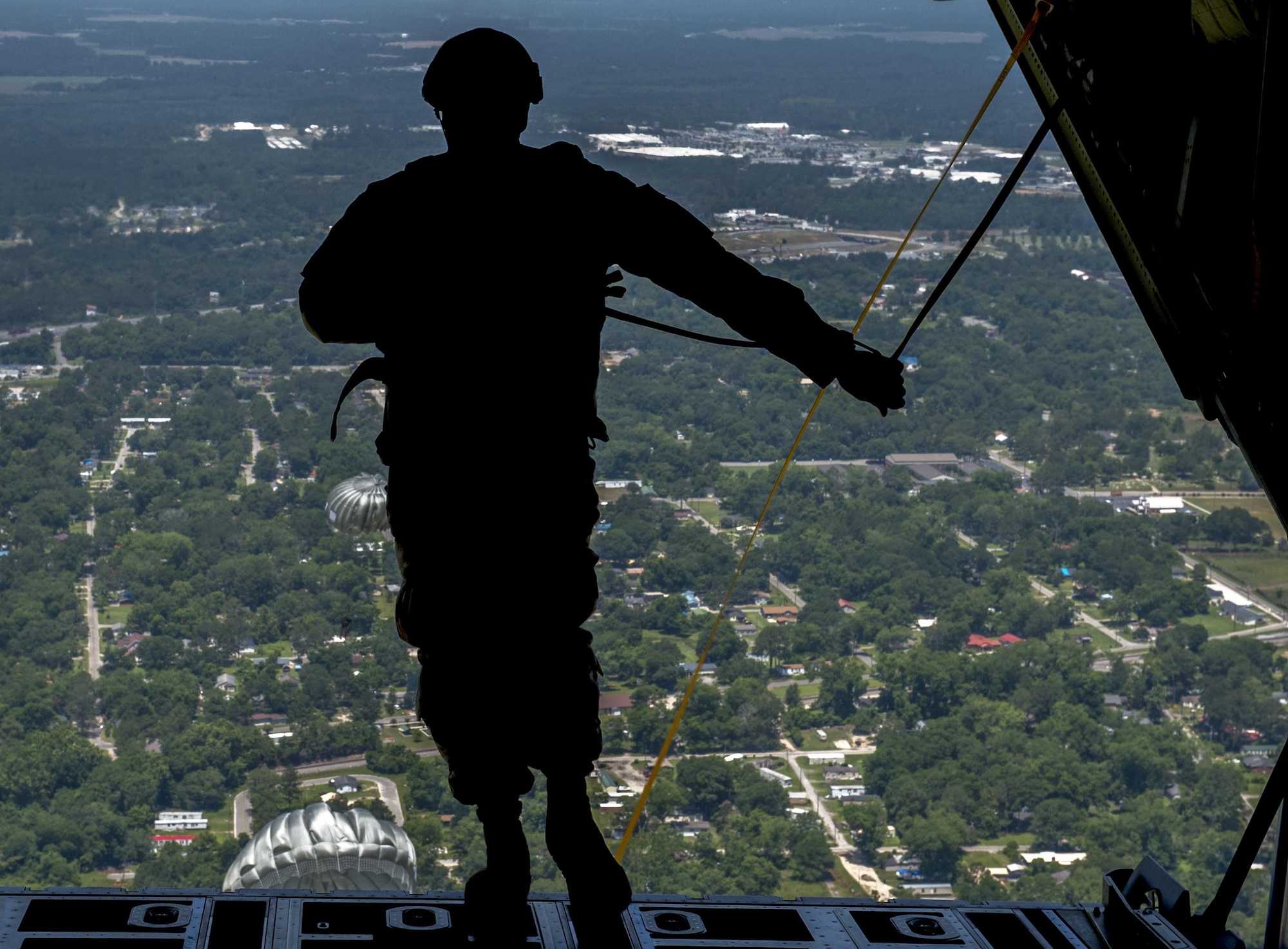 A U.S. Air Force Airman from the 93d Air Ground Operations Wing, prepares to jump out of an HC-130J Combat King II, June 17, 2016 over the Lee Fulp drop zone in Tifton, Ga. The 93d AGOW activated in 2008 and became the first wing to provide highly-trained ground combat forces capable of integrating air and space power into the ground scheme of fire and maneuver. (U.S. Air Force photo by Tech. Sgt. Zachary Wolf/Released)