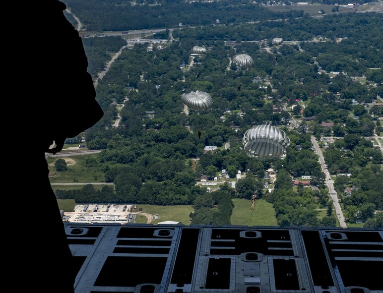 U.S. Air Force Airmen from the 93d Air Ground Operations Wing, jump out of an HC-130J Combat King II, June 17, 2016 over the Lee Fulp drop zone in Tifton, Ga. The wing members conduct offensive and defensive ground combat operations worldwide to protect expeditionary aerospace forces with an airborne capability. (U.S. Air Force photo by Tech. Sgt. Zachary Wolf/Released)