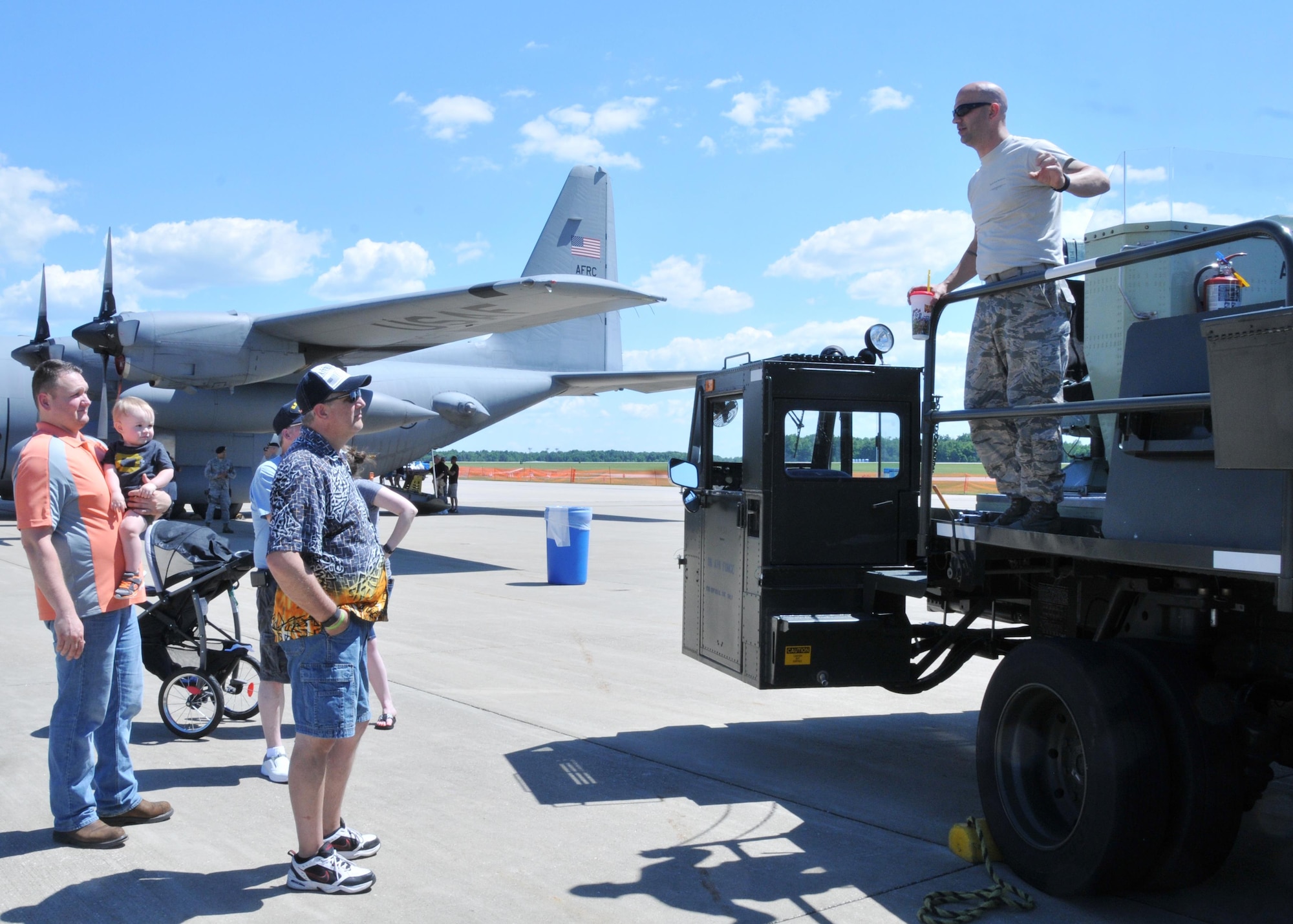 Tech. Sgt. Jeremy Rogers, and aerial spray maintainer with the 910th Maintenance Squadron, explains the components of the Modular Aerial Spray System during the Department of Defense preview day of the 2016 Youngstown Air Reserve Station Open House, here June 17th, 2016. The Youngstown Air Reserve Station Open House drew approximately 7000 guests to see the equipment, mission and personnel of YARS. The preview day was intended to allow DoD card holders and their family members early access to the event. (U.S. Air Force photo/Staff Sgt. Rachel Kocin)