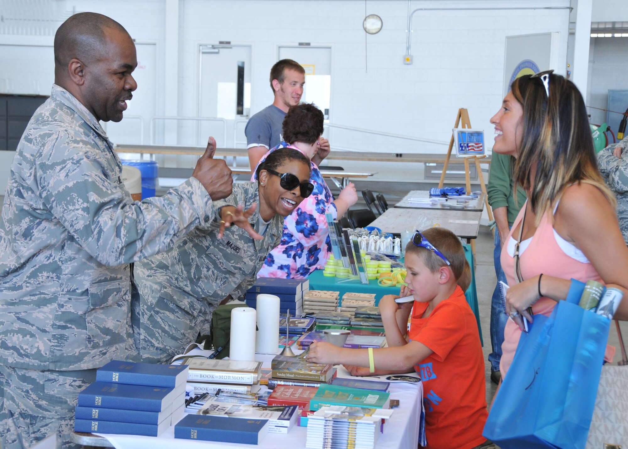 Lt. Col. Klavens Noel, 910th Airlift Wing Chaplain, and Tech. Sgt. Elizabeth Majors, Chaplain Assistant give out information to guests here during the Department of Defense preview day of the 2016 Youngstown Air Reserve Station Open House, here June 17th, 2016. The Youngstown Air Reserve Station Open House drew approximately 7000 guests to see the equipment, mission and personnel of YARS. The preview day was intended to allow DoD card holders and their family members early access to the event. (U.S. Air Force photo/Staff Sgt. Rachel Kocin)