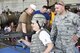 Tech. Sgt. Daniel Bugaj, a 910th Security Forces Squadron fire team member, helps an air show guest try on a protective vest and helmet during the 2016 Youngstown Air Reserve Station Open House here, June 18. The Security Forces Squadron set up an interactive display as part of the 2016 Youngstown Air Reserve Station Open House which drew approximately 7000 guests to see the equipment, mission and personnel of YARS. (U.S. Air Force photo/Eric White)