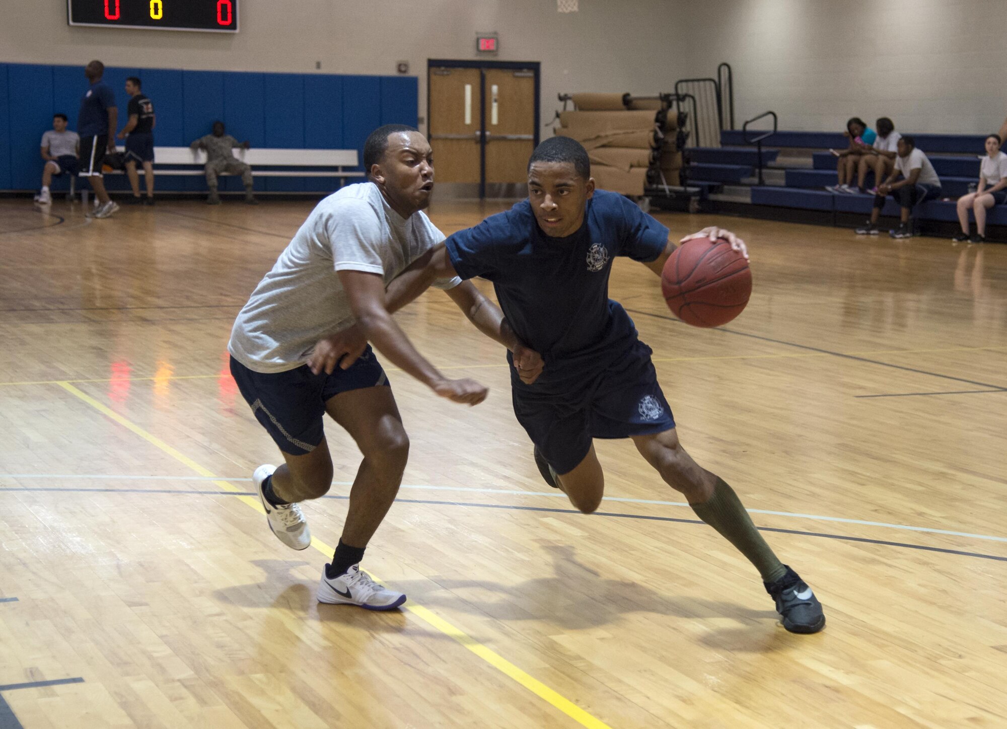 U.S. Air Force Airman Basic Tyrell Thompson, 23d Civil Engineer Squadron firefighter, blows past a defender during Sports Day, June 17, 2016, at Moody Air Force Base, Ga. During the game, the 23d CES took on the 23d Force Support Squadron, battling it out for third place. (U.S. Air Force photo by Airman 1st Class Janiqua P. Robinson/Released)