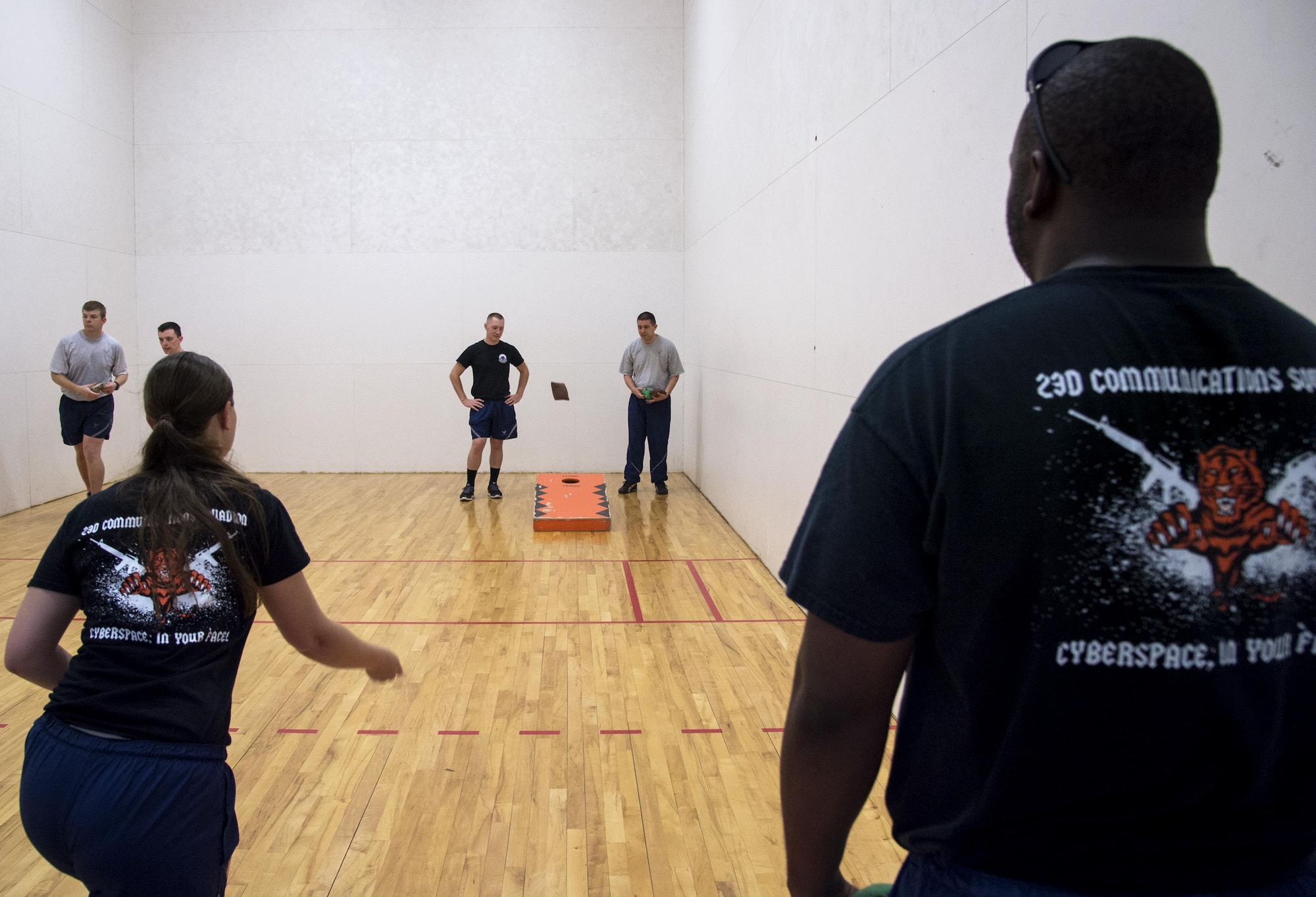 U.S. Air Force Airmen from the 23d Mission Support Group warm up in preparation for a cornhole tournament during Sports Day, June 17, 2016, at Moody Air Force Base, Ga. Various squadrons belonging to the 23d MSG competed against each other during the two-on-two tournament. (U.S. Air Force photo by Airman 1st Class Janiqua P. Robinson/Released)