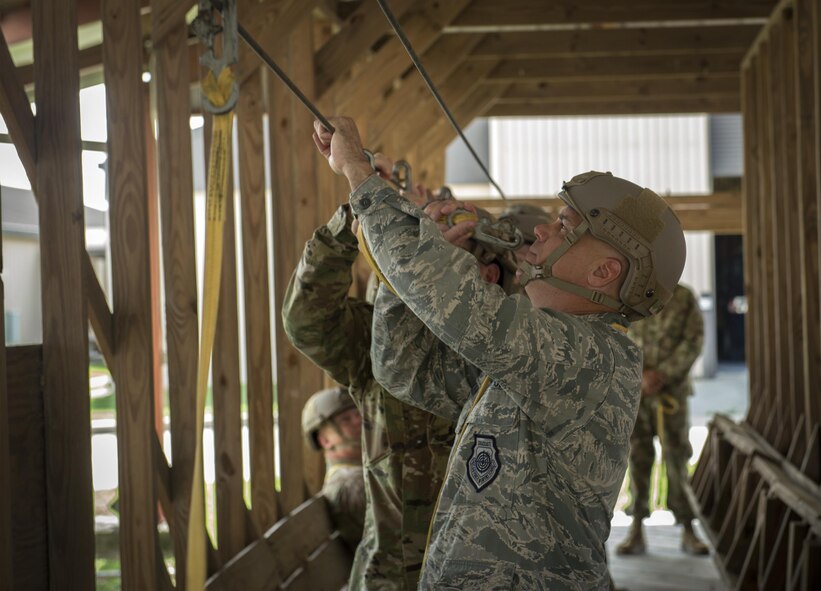 U.S. Air Force Col. Eric Trychon, 93d Air Ground Operations Wing vice commander, hooks up his  static line during jump practice, June 16, 2016 at Moody Air Force Base, Ga. The static line is responsible for pulling out the parachute as the member exits the aircraft. (U.S. Air Force photo by Tech. Sgt. Zachary Wolf/Released)