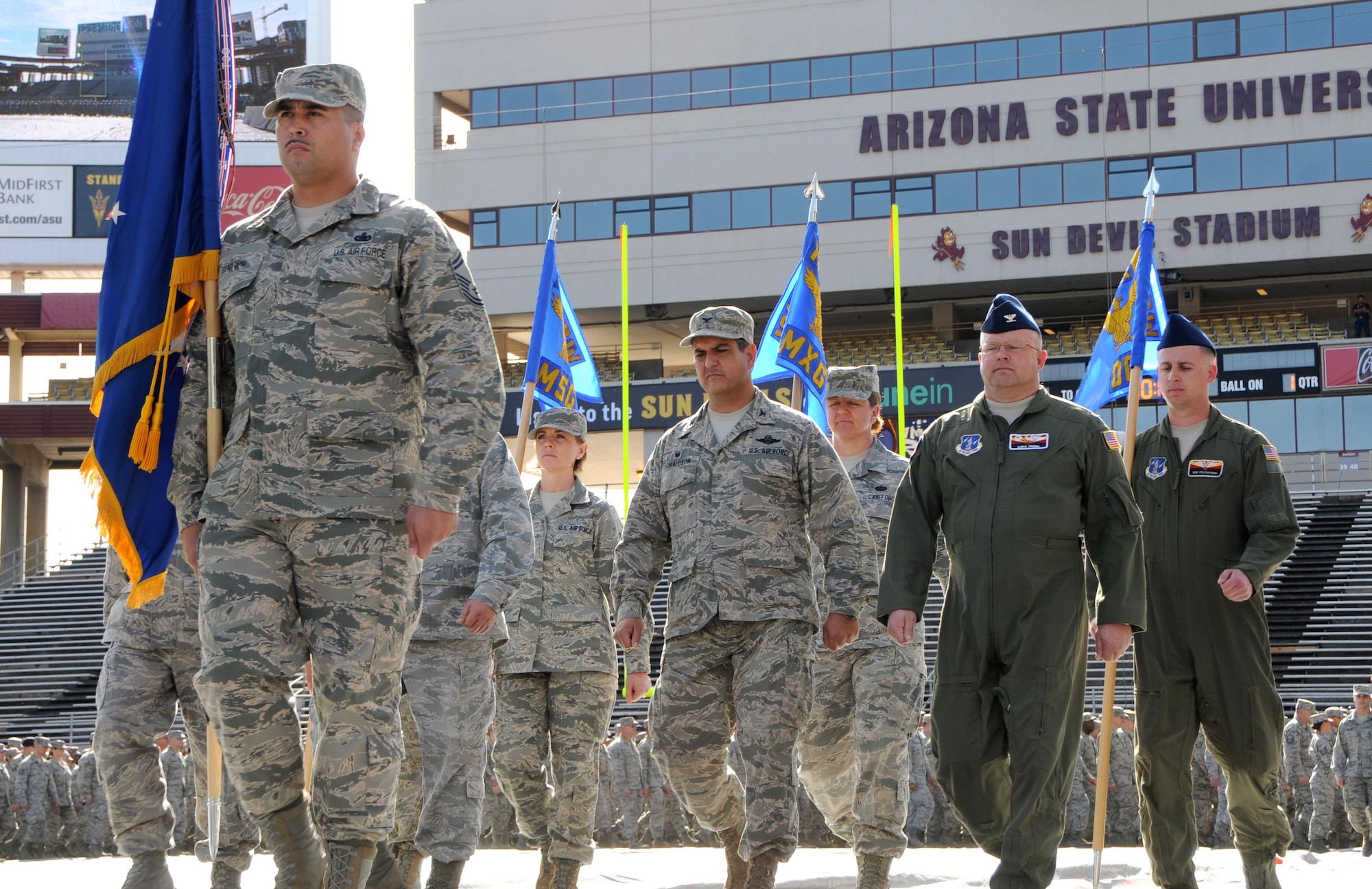 Senior Master Sgt. Alex Brown, front, leads the Arizona Air National Guard’s 161st Air Refueling Wing during a march at Sun Devil Stadium in Tempe, Ariz., Dec. 7, 2014. Brown’s prior experience as military training instructor made him the unit’s resident expert on drill and ceremonies and gave him skills that, he said, helped him graduate from law school. Brown recently passed the Arizona bar exam and fulfilled a personal dream to become an attorney. (U.S. Air National Guard photo/Tech. Sgt. Courtney Enos)