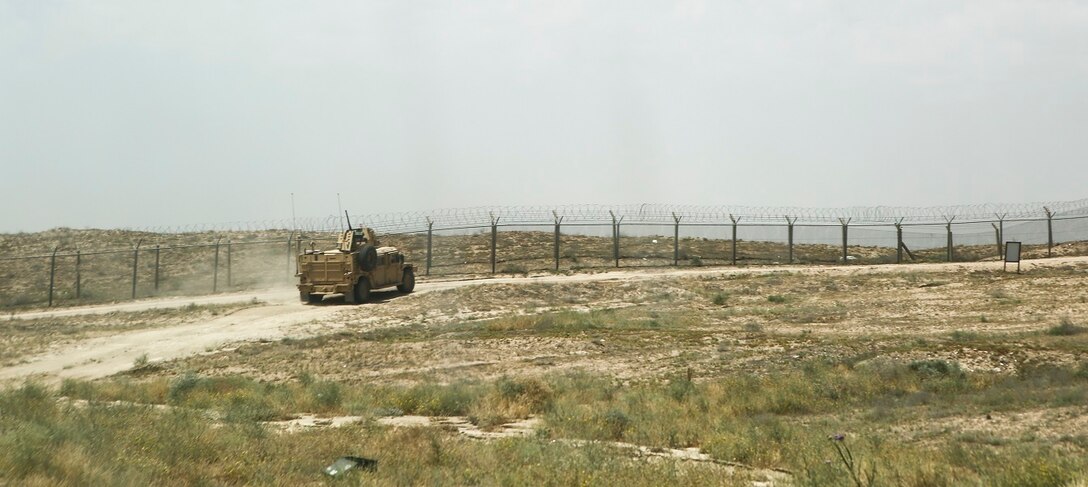 A humvee departs an explosives range aboard Task Force Al Taqaddum Air Base, Iraq.  Explosive Ordnance Disposal Marines with Special Purpose Marine Air Ground Task Force - Crisis Response - Central Command 16.2 assigned to TFTQ  are currently engaged in building partership capacity with Iraqi Security Forces.