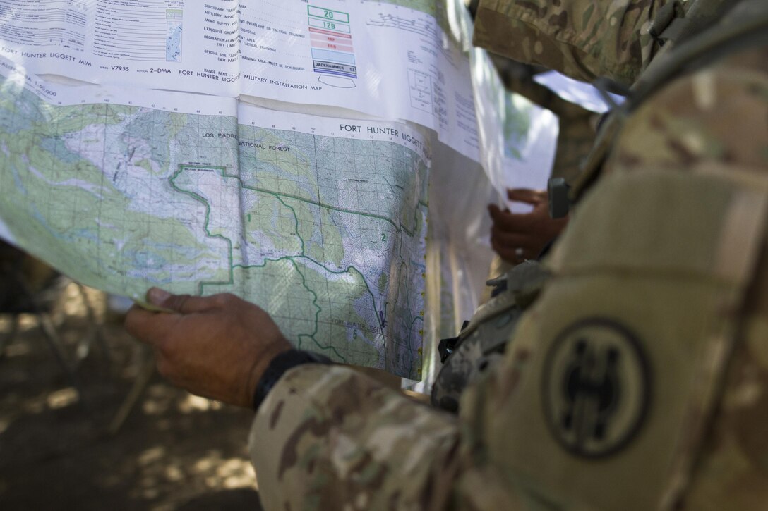 Soldiers from the 341st Military Police Company, of Mountain View, California, use a map to prepare for a simulated mission during the Combat Support Training Exercise (CSTX) at Fort Hunter-Liggett, California, on 18 June. 54 units from across the U.S. Army Reserve, National Guard, Active Army, U.S. Air Force, U.S. Navy, and Canadian Army participate in the 84th CSTX of the year, CSTX 91-16-02, hosted by the 91st Training Division. (Photos by Spc. Victoria Friend)