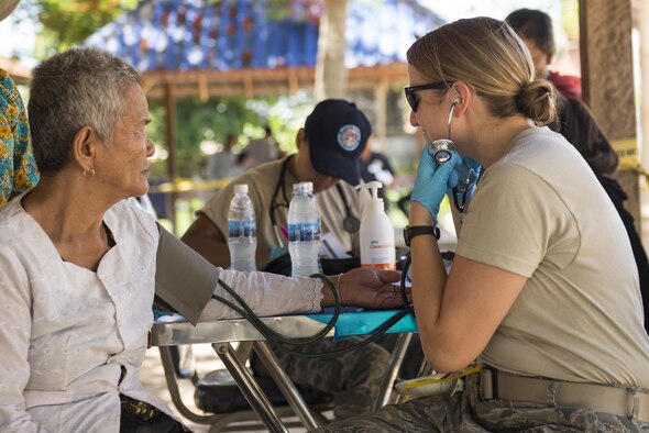 Tech. Sgt. Nicole Olive, a medical technician with the 124th Fighter Wing, Idaho Air National Guard, listens to the heartbeat of a patient during Pacific Angel 16-2 in the Kampot province, Cambodia, June 13, 2016. The Idaho National Guard partnered with Cambodia’s armed forces to train together through the ANG’s State Partnership Program. The program is designed to provide a consistent, enduring and genuine presence, built over time through professional, personal and institutional relationships that span continents and decades. (U.S. Air Force photo/Senior Airman Omari Bernard)