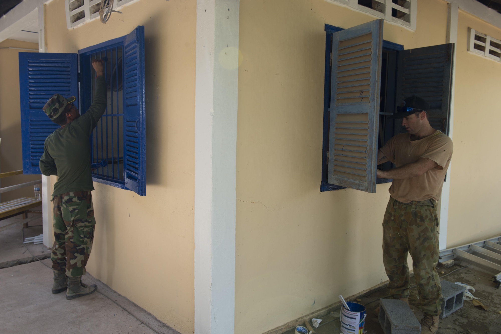 Royal Cambodian Armed Forces Sgt. Ngin Samnang, Royal Cambodian Army engineer,  works alongside Royal Australian Air Force Lead Aircraftsman Anthonly Holmes, 65th Squadron engineer; Townsville, Australia,  to paint the shudders of a health center during Pacific Angel 16-2 June 15, 2016, in Kampot Province, Cambodia. Pacific Angel is a humanitarian assistance/civil military operation mission that builds partner capacity through medical/health outreach, engineering civic projects and subject matter exchanges. The U.S. military is always seeking opportunities to strengthen its relationship with other nations’ militaries through activities and engagements such as Pacific Angel. (U.S. Air Force photo by Senior Airman Omari Bernard/Released)