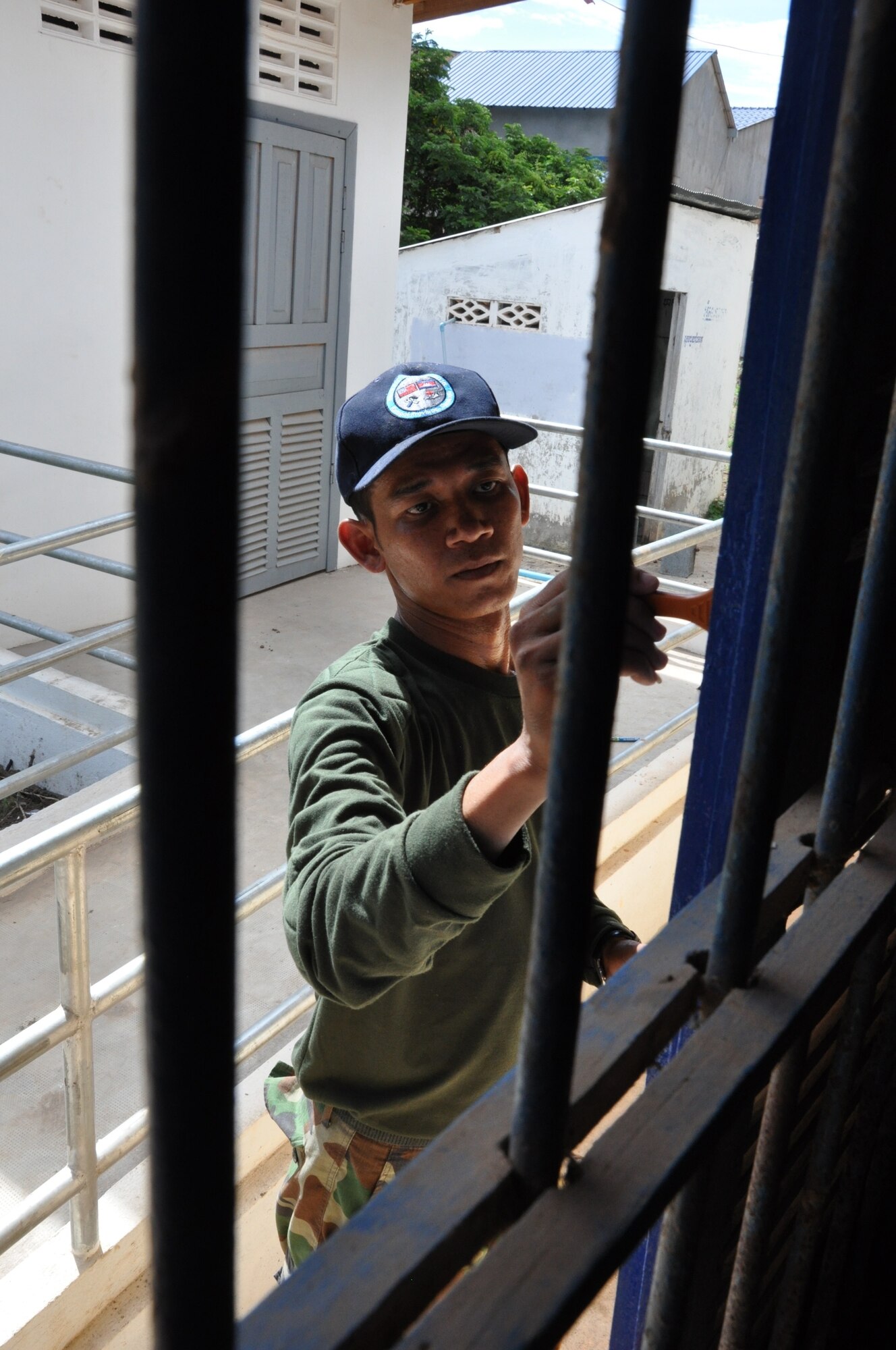 Royal Cambodian Air Force First Sgt. Long Rathna paints a window panel at the Toukmeas Health Center June 15, 2016, as part of Pacific Angel 16-2 in Kampot Province, Cambodia. Multinational civil engineers spent approximately 2,100 man-hours working on restoration projects for four local schools and two medical facilities, impacting the lives of more than 1,000 individuals daily. The Pacific Angel mission enhances participating nations’ humanitarian assistance and disaster relief capabilities while providing needed services to people throughout the Indo-Asia-Pacific region. (U.S. Air Force photo by Capt. Susan Harrington/Released)