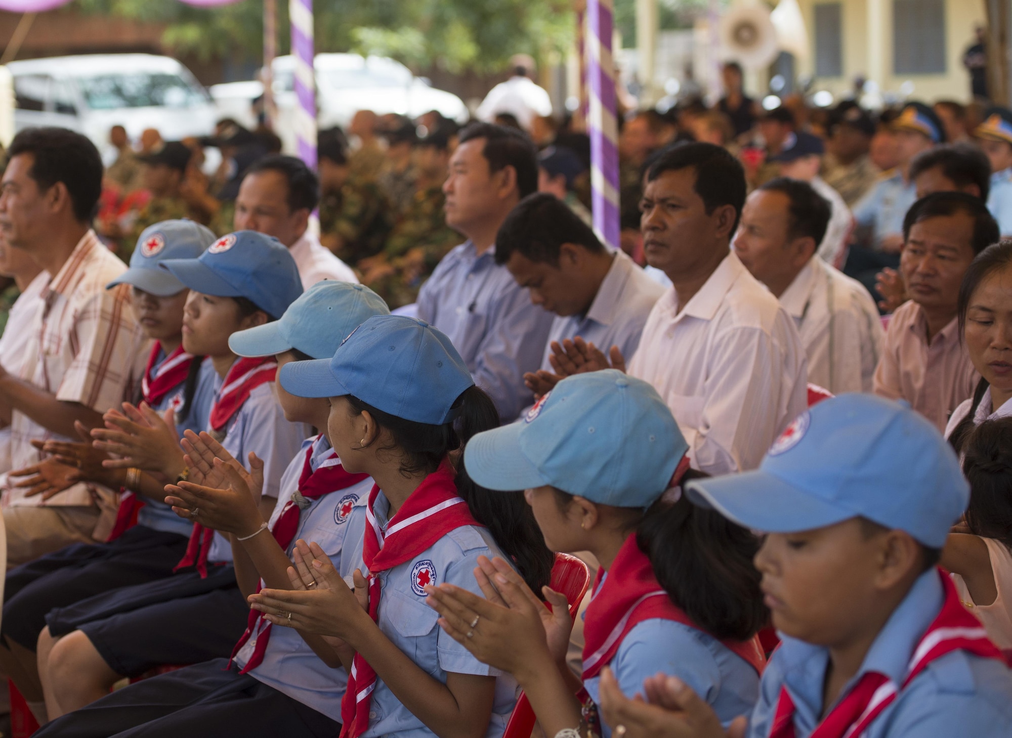 Residents of Kampot Province, Cambodia, and members of the Pacific Angel Team attend the Pacific Angel 16-2 closing ceremony at Wat Steung Primary School June 20, 2016, in Kampot Province, Cambodia. Pacific Angel 16-2 is a humanitarian assistance/civil military operation mission designed to foster relations and partnerships between the U.S., Cambodia and several other partner nations through subject matter expert exchanges, medical aid and civil engineering projects. (U.S. Air Force photo by Senior Airman Omari Bernard/Released)